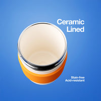 Orange ceramic-lined container with text on a blue background